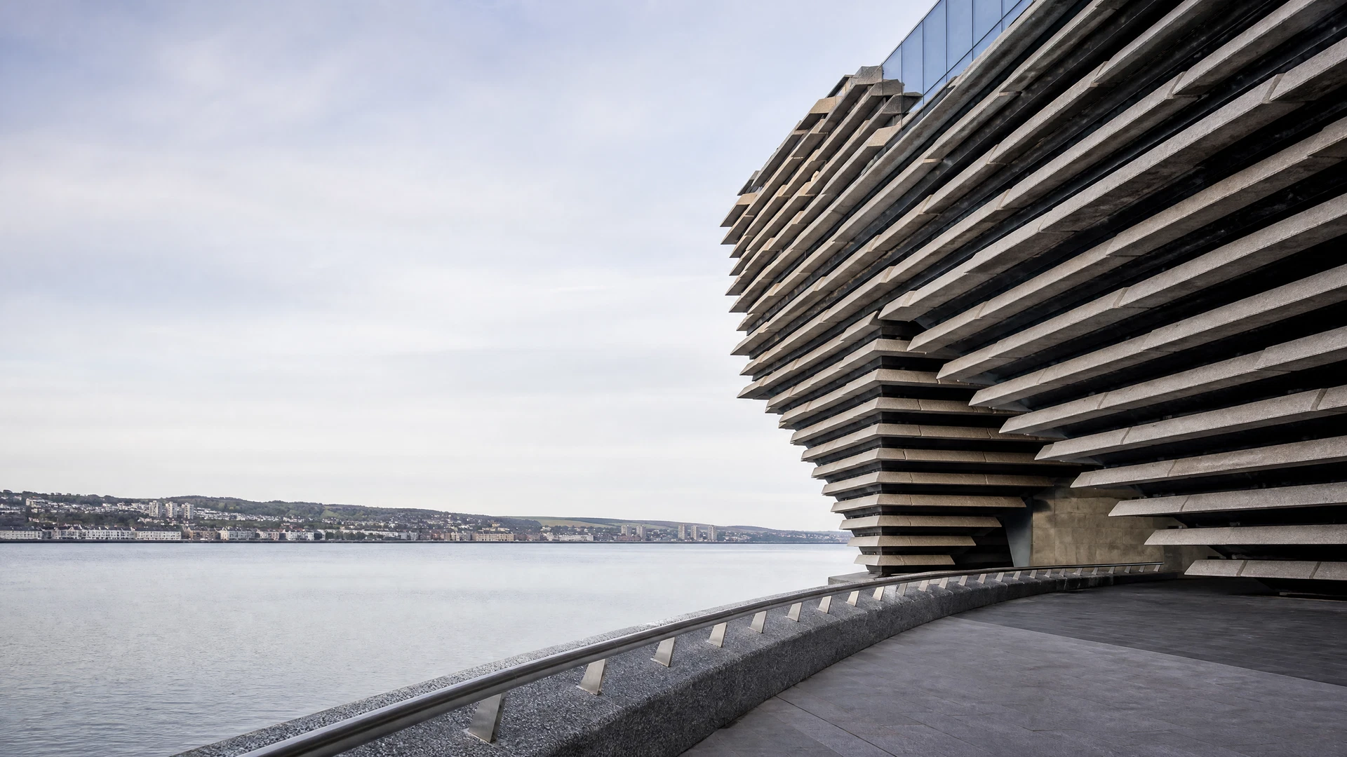 Landmark-oriented editorial image of contemporary layered waterfront architecture in Dundee